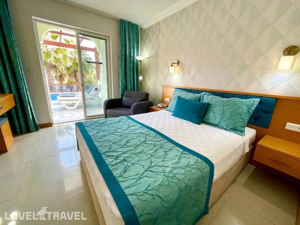 фотографии номера Двухместный номер Swim-Up двуспальная кровать отеля Green Forest Holiday Village в Турция(Олюдениз) - фото №2